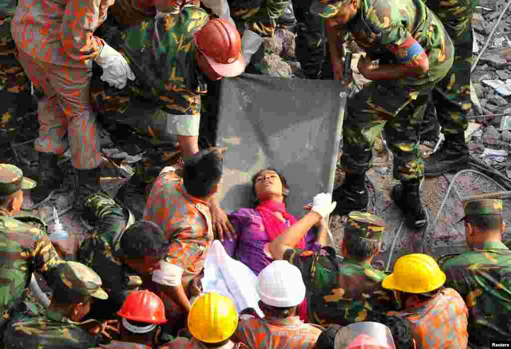 Rescue workers remove a woman alive from the rubble of the Rana Plaza building 17 days after the building collapsed in Savar, Bangladesh. More than 1,000 people were killed in the disaster. (Reuters/Sohel Ahmed)