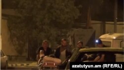 Armenia - A screenshot of police video shows two opposition gunmen hospitalized after being wounded outside a Yerevan police station occupied by them, 26Jul2016.