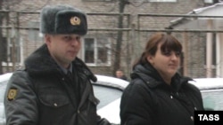 Activist Taisia Osipova (right) is escorted to a court in Smolensk in December 2011.