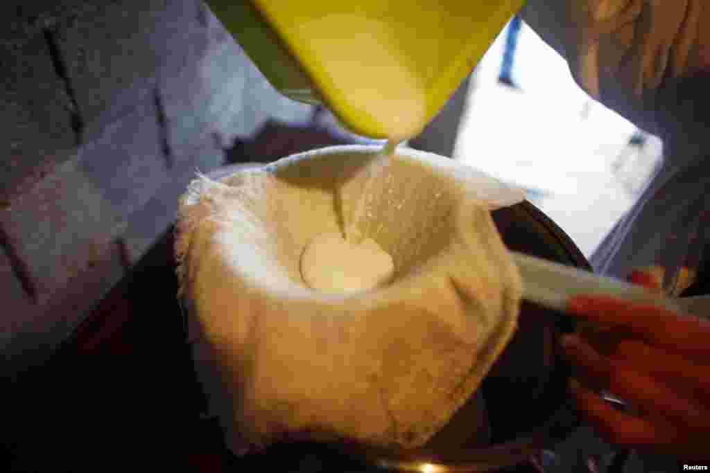 A woman pours fresh donkey milk at a farm in Zasavica Resort