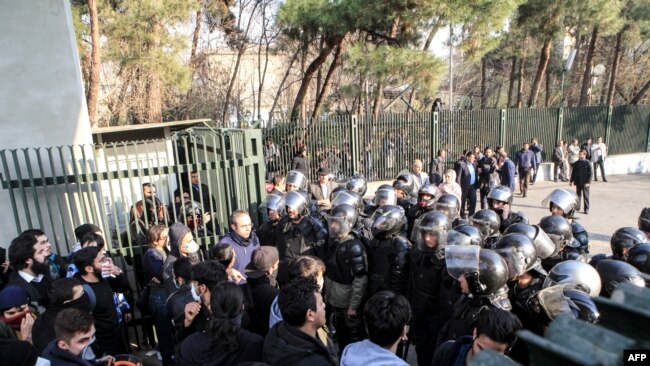 Iranian students scuffle with police at the University of Tehran during a demonstration driven by anger over economic problems, in the capital Tehran on December 30, 2017.