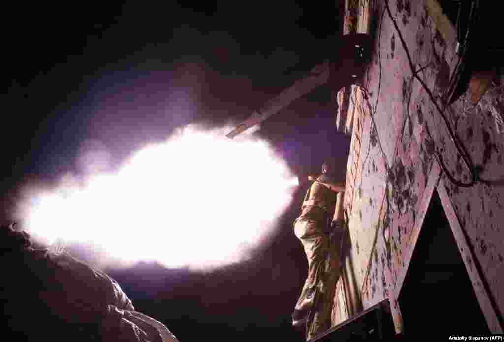A Ukrainian serviceman fires a grenade launcher during night combat with Russia-backed separatists near Avdiyivka, in the Donetsk region, on September 13. (AFP/Anatoliy Stepanov)