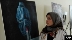 A visitor attends an exhibition in Herat to mark International Women's Day.