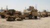 File Photo:US soldiers stand next to army vehicles during a logistical operation in Iraq.