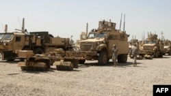 File Photo:US soldiers stand next to army vehicles during a logistical operation in Iraq.