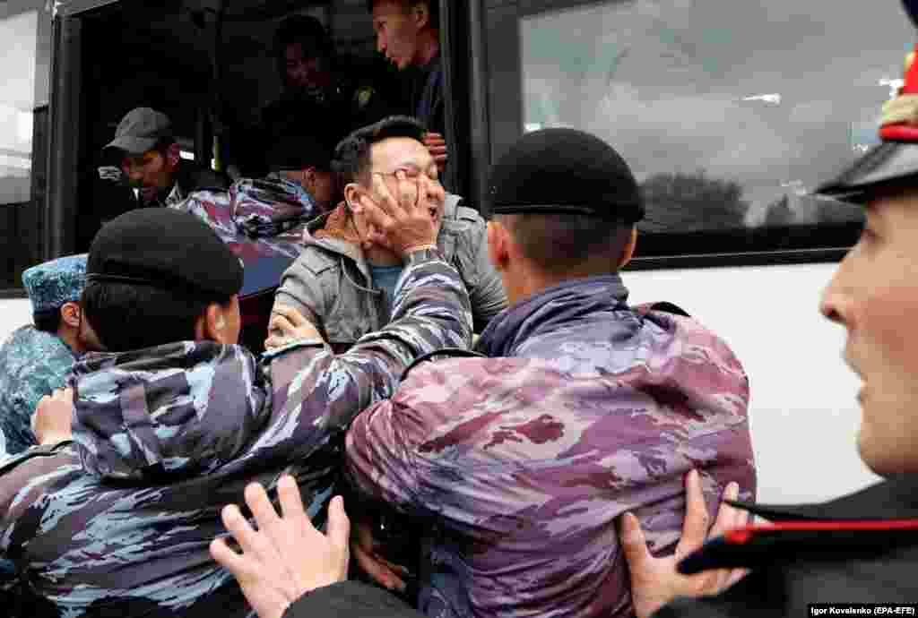 Kazakh police detain opposition supporters during a protest calling for free and fair elections during the presidential election in Nur-Sultan on June 9. (epa-EFE/Igor Kovalenko)