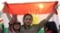 A woman holds a flag during a gathering to support the Kurdistan independence referendum on September 21. 