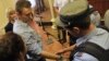 A policeman puts handcuffs on opposition leader Aleksei Navalny inside the courtroom in Kirov on July 18.