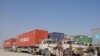 Pakistani drivers rest next to their NATO supply trucks on the Afghan-Pakistani border in Baluchistan Province on November 29.