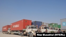 Pakistani drivers rest next to their NATO supply trucks on the Afghan-Pakistani border in Baluchistan Province on November 29.