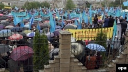 Crimean Tatars attend a commemoration ceremony in the Akmechet district of Simferopol on May 18.