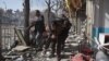 Afghan volunteers carry a victim at the scene of a car bomb that exploded in front of the old Ministry of Interior building in Kabul on January 27.