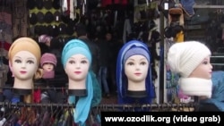 Mannequins in a shop show the head-scarf style officially promoted for women in Uzbekistan.