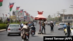 FILE: Afghan policemen at a checkpoint in southern Afghanistan.