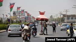 AFGHANISTAN -- Afghan policemen stand guard at a checkpoint ahead of parliamentary election in Kandahar, October 18, 2018