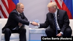 U.S. President Donald Trump (right) shakes hands with Russia's President Vladimir Putin in Hamburg, Germany, in July, the only face-to-face meeting between the two, so far.