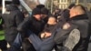 Үкіметке қарсылық шеруі өтеді деп жариялаған алаңға келген адамды полиция көлікке күштеп салып жатқан сәт. Алматы, 22 ақпан 2020 жыл.