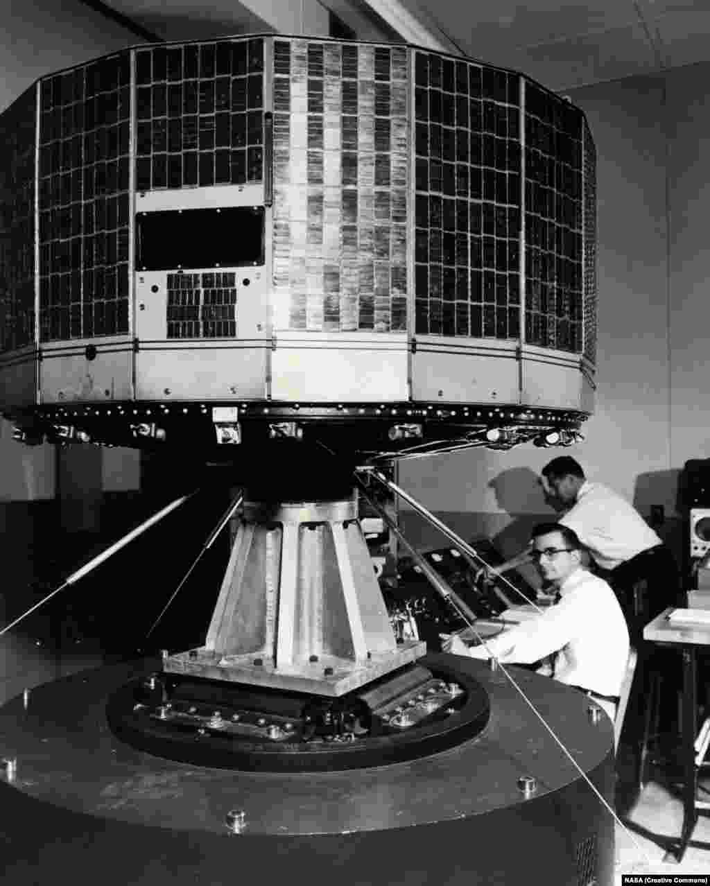 NASA&rsquo;s Tiros 1 weather satellite being jiggled during a test to see if it will survive the violent ride into space in 1960. Tiros was the first attempt at a weather satellite that could transmit a view of incoming weather from its two cameras to a control center back on Earth.
