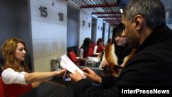 A passenger checks in for a flight at Tbilisi airport. Russia's Transport Ministry announced that Russian airlines would operate seven flights weekly between Moscow and Tbilisi -- a move Georgian President Salome Zurabishvili called "unacceptable." 