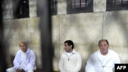 Former ministers Zuheir Garranah (right) and Ahmed al-Maghrabi (left) and former senior member of the National Democratic Party Ahmed Ezz (center) sit behind bars in Cairo in February.