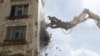 Russia -- An excavator wrecks a building, which is part of the old five-storey apartment blocks demolition project launched by the city authorities, in Moscow, Russia, June 20, 2017