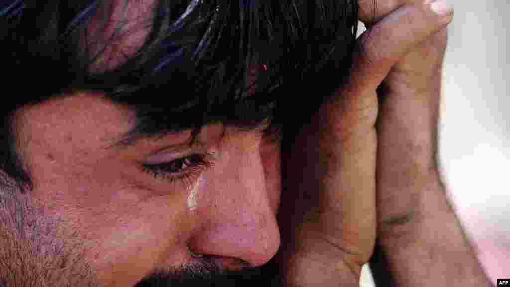 A Pakistani man grieves after his brother was killed in a car blast on the outskirts of Peshawar on February 23. (AFP PHOTO/A. MAJEED)