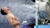 Jerzy Janowicz of Poland cools down during the Australian Open tennis tournament on January 16.