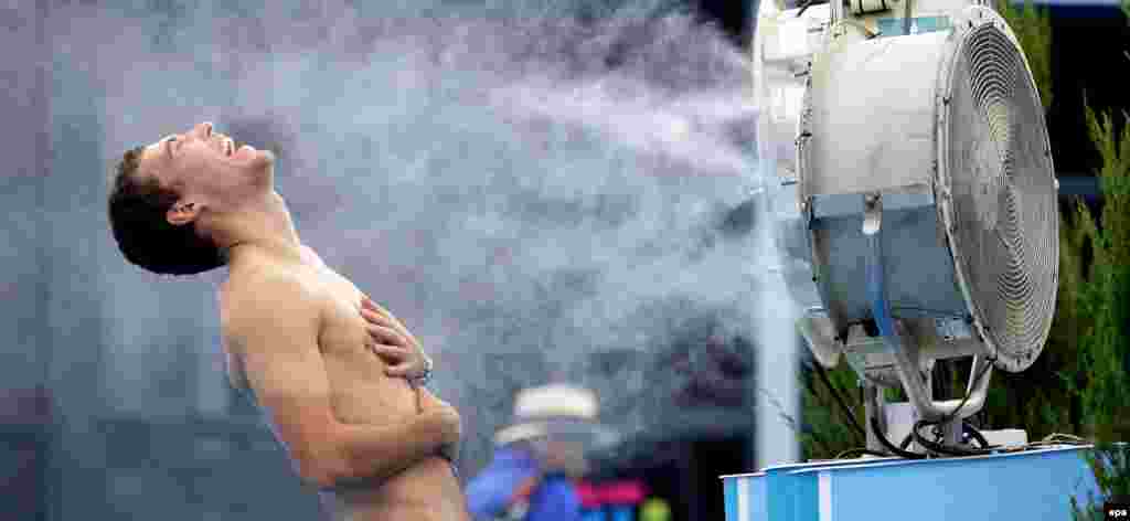 Jerzy Janowicz of Poland cools down during the Australian Open tennis tournament on January 16.