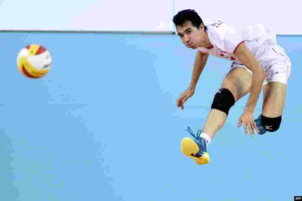 Iran's Seyed Mohammad Moussavi Eraghi serves during the men's volleyball final between Japan and Iran at the Songnim Gymnasium in Incheon, South Korea, during the 17th Asian Games. Iran won gold. (AFP/Martin Bureau)