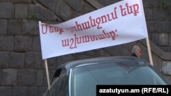 Armenia - A poster saying "We demand work" is displayed by workers protesting against the closure of a copper smelter in Alaverdi, 19 October, 2018.