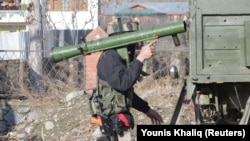 An Indian Army soldier carries a rocket launcher near the site of a gunbattle in Kashmir between suspected militants and Indian security forces earlier this month. 