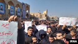 Protesters in the central Iranian city of Yazd holding placards, criticizing President Hassan Rouhani. Nov. 10, 2019
