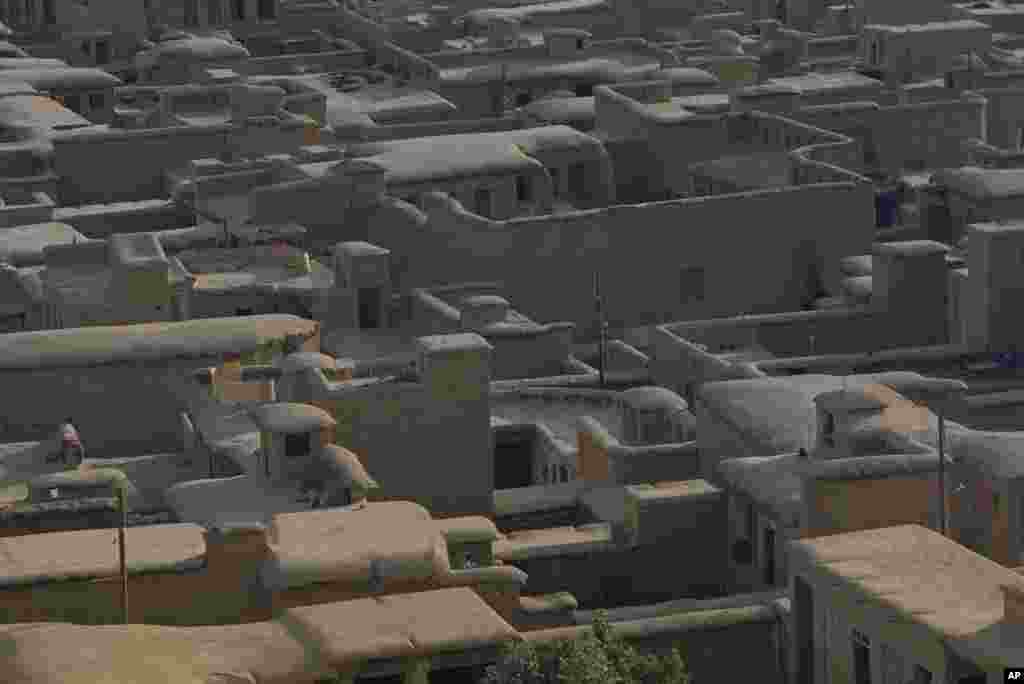 A small village near Persepolis in southwestern Iran is shown, July 1971. The buildings are set at the foot of a mountain and are made of sun-dried mud bricks and have mud and straw-covered roof tops. (AP Photo/Horst Faas)