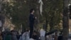 The image of a young Iranian woman protesting against the compulsory hijab quickly went viral on social media.