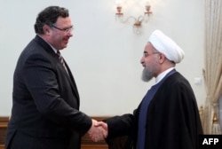 Iranian President Hassan Rohani (R) meets with Patrick Pouyanne Chairman and CEO of French energy company Total, after signing an offshore gas field agreement in Tehran, July 3, 2017