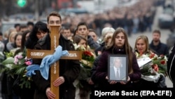 People take part in a mourning procession for Oliver Ivanovic in Mitrovica on January 17.