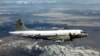 A U.S. Navy EP-3 is shown flying over an unknown location.