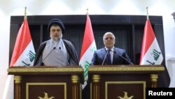 Iraqi Shi'ite cleric Moqtada al-Sadr (left) and Iraqi prime Minister Haider al-Abadi. (file photo)