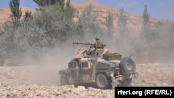 FILE: An Afghan army vehicles moving through a rural district in Faryab province.