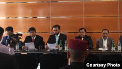 Brahamdagh Bugti (c) reading from a paper during a party meeting in Geneva on September 19.