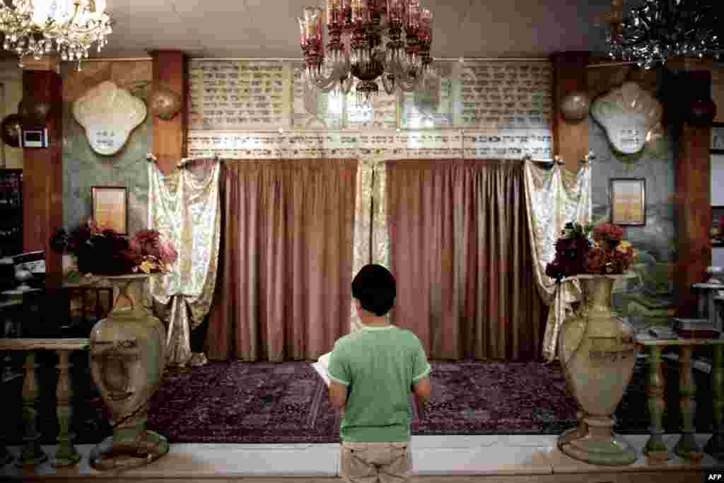 A Jewish boy reads the Torah at a synagogue in downtown Tehran.