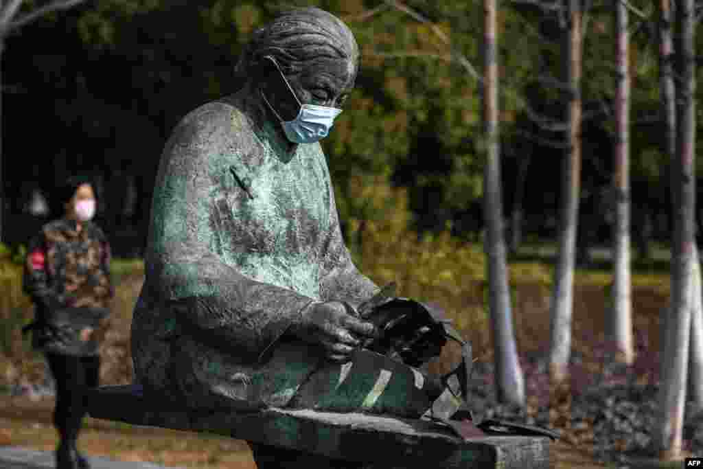 A sculpture wearing a protective face mask is seen at a park in Huaian in China&#39;s eastern Jiangsu Province, amid an outbreak of the coronavirus that originated from Hubei&#39;s provincial capital city of Wuhan. The number of deaths in China from the virus, which was first detected in December, was 361 as of February 2, a sharp increase from just 57 from the previous day. (AFP/Stringer)