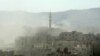 Syria -- Smoke above buildings following what Syrian rebels claim to be a toxic gas attack by pro-government forces in eastern Ghouta, on the outskirts of Damascus, August 21, 2013