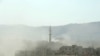 Smoke rises following what Syrian rebels claim to be a toxic-gas attack by pro-government forces on the outskirts of Damascus on August 21.