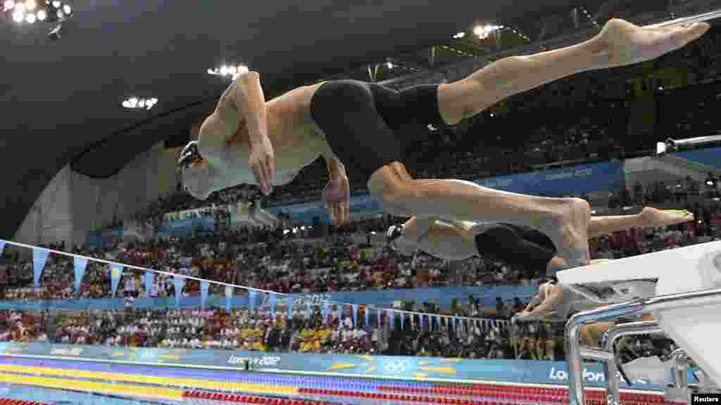 Michael Phelps of the United States dives into the pool at the start of the men's 200-meter individual medley swimming final at the Olympics. During the London Games, Phelps became the most decorated Olympian of all-time, ending his stellar career with a total of 22 medals, including 18 golds. (Reuters/Adam Pretty)