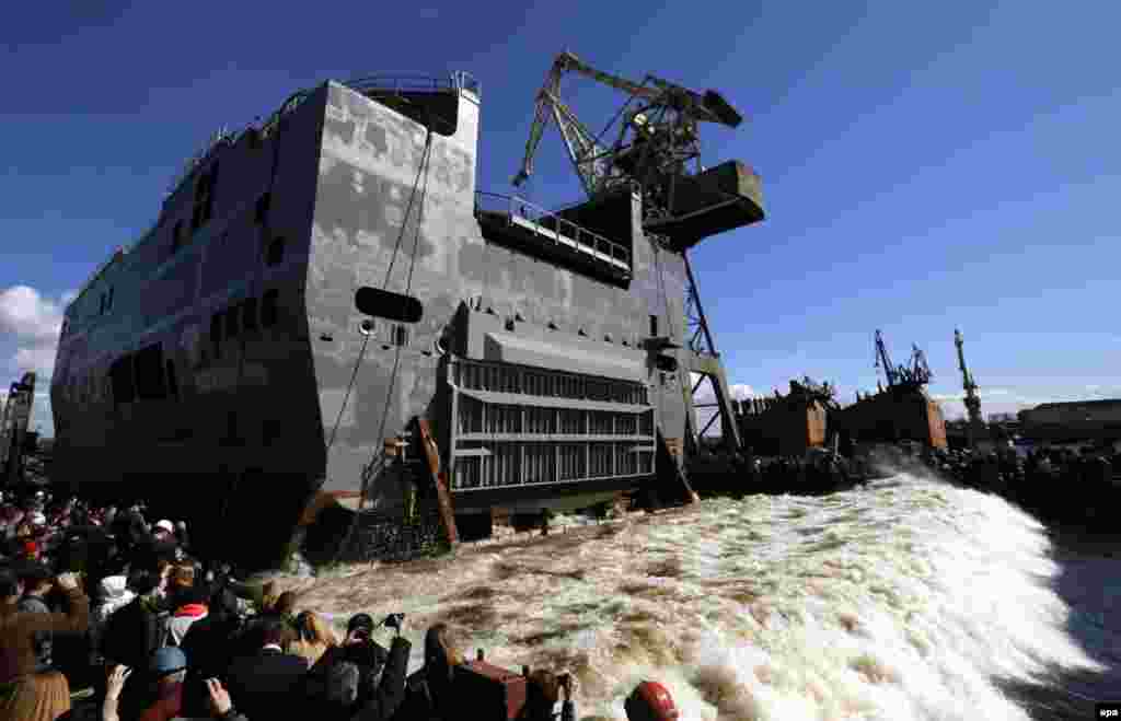 The launching of the completed stern section of the &quot;Sevastopol&quot; Russian Mistral-class amphibious assault ship at the Baltic Shipyard in St. Petersburg. (EPA/Anatoly Maltsev)