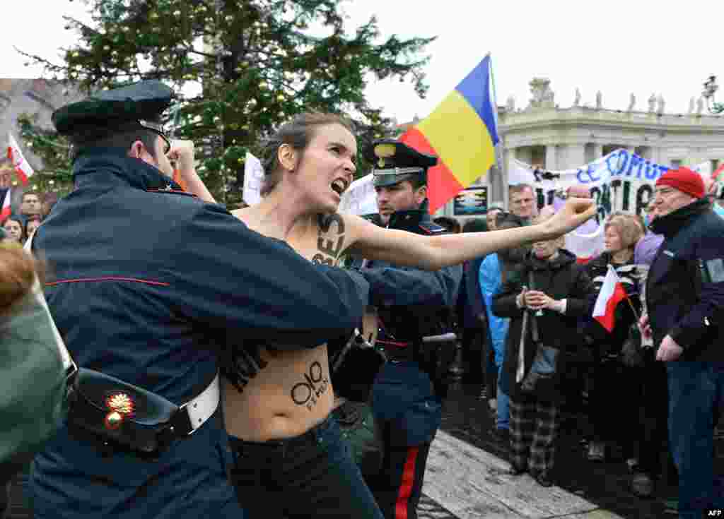 Police try to stop an activist of the Ukrainian feminist group Femen from protesting against the Catholic Church's stand on same-sex marriage on St. Peter's Square at the Vatican on January 13. (AFP/Vincenzo Pinto)