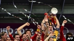 Spanish players celebrate with the trophy after winning the Euro 2012 football championships final match Spain vs Italy on July 1, 2012 at the Olympic Stadium in Kiev. AFP PHOTO / GIUSEPPE CACACE