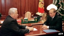Russia President Boris Yeltsin speaks with then-Prime Minister Vladimir Putin at the Kremlin on December 31, 1999, the day that Yeltsin would resign and appoint the former KGB agent as the country's acting leader.