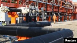 A worker walks past infrastructure on D Island, the main processing hub at the Kashagan offshore oil field in the Caspian Sea. (file photo)